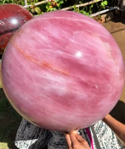 Large natural Rose Quartz Sphere weighing approximately 150 kg with soft pink crystal tones for luxury interior décor and statement display.
